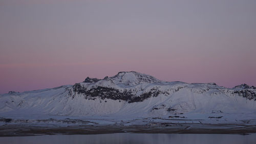 Scenic view of snowcapped mountains against sky during sunset