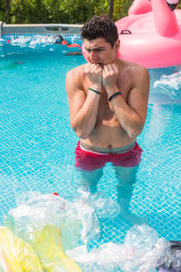 Young man swimming in pool