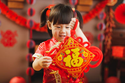 Full length of happy girl in traditional clothing