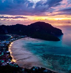 Scenic view of sea against dramatic sky during sunset