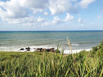 Scenic view of sea against cloudy sky