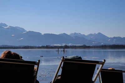 Scenic view of lake and mountains against clear sky