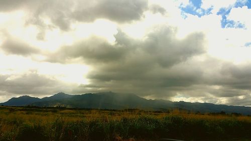 Scenic view of mountains against cloudy sky