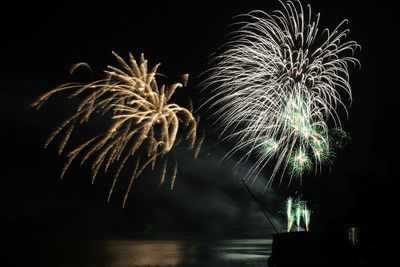 Low angle view of firework display at night