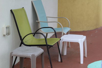 Empty chairs and table against wall at home