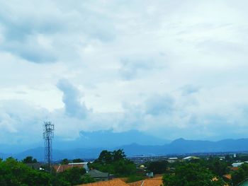 Scenic view of mountains against cloudy sky