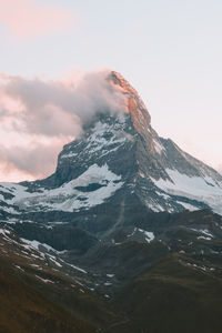 Scenic view of snowcapped mountains against sky during sunset