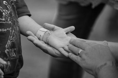 Close-up of people with holding hands