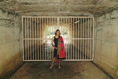 Full length portrait of woman standing in tunnel