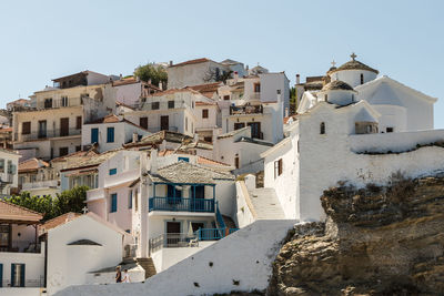 Buildings in town against clear sky