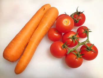 High angle view of tomatoes against white background