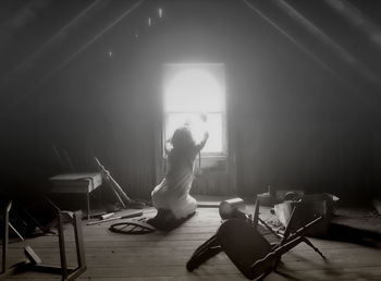 Woman sitting on hardwood floor