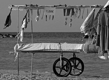 Shop on beach by sea against sky