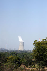 Smoke emitting from chimney against clear sky