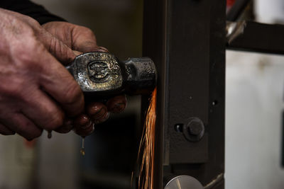 Cropped hand of man repairing car