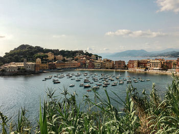 Scenic view of lake by buildings against sky