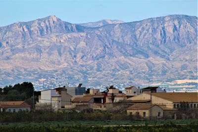 Houses on mountain against sky