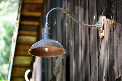 Close-up of light bulb hanging against wall