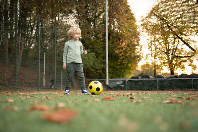 A little boy plays soccer on the soccer field