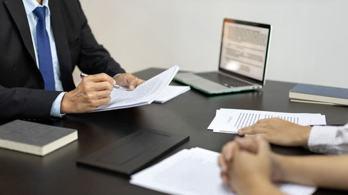 Midsection of business colleagues working in office