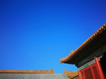 Low angle view of building against clear blue sky