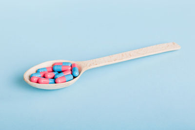 High angle view of spoon on blue background