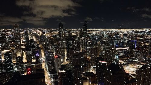 High angle view of illuminated city buildings at night
