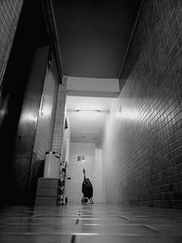 Rear view of people walking in tunnel