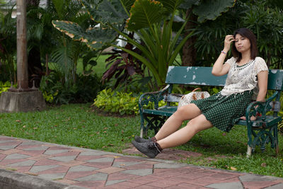 Portrait of smiling woman sitting in park