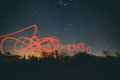 Light painting against sky at night