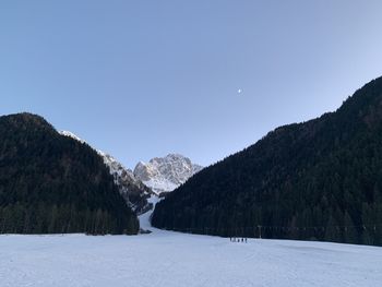 Scenic view of snowcapped mountains against clear sky