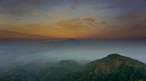 Scenic view of mountain against dramatic sky