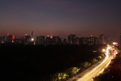 Illuminated city against sky at night