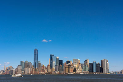 Modern buildings in city against blue sky