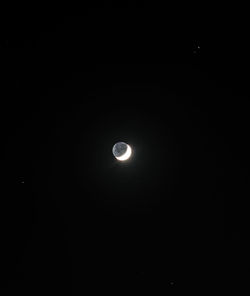 Low angle view of moon against sky at night