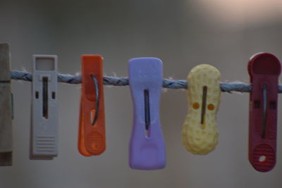 Close-up of clothespins hanging on clothesline