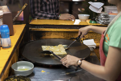 Midsection of woman preparing food