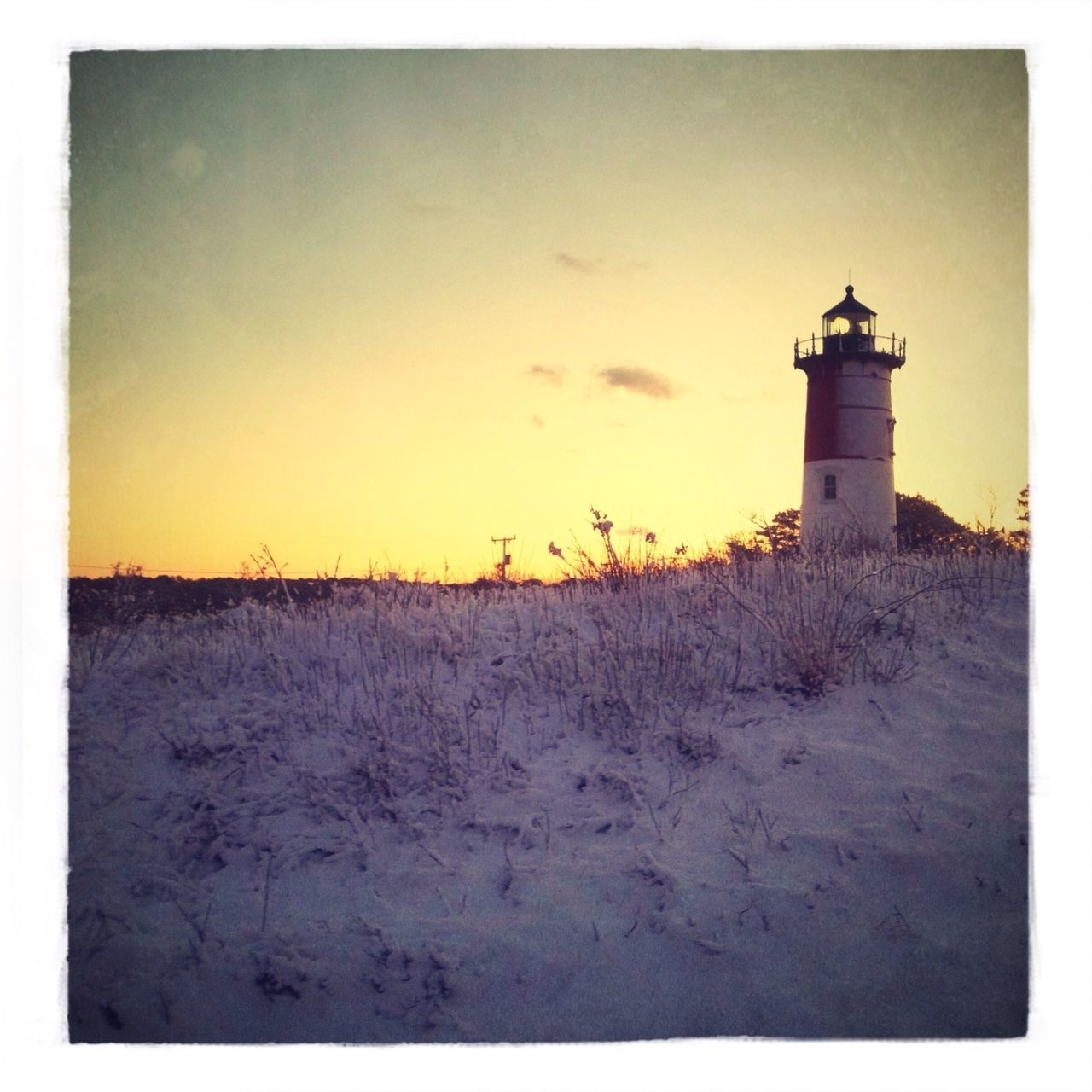 LIGHTHOUSE AGAINST SKY DURING WINTER