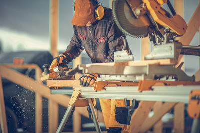 Midsection of man working at workshop