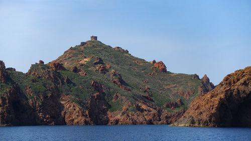 Scenic view of sea and mountain against sky