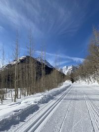 Snow covered landscape against sky