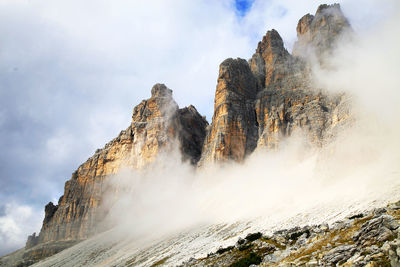 Low angle view of clouds covering dolomites against sky