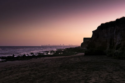 Scenic view of sea against clear sky during sunset