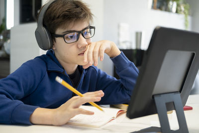 Portrait of teenage boy sitting on table