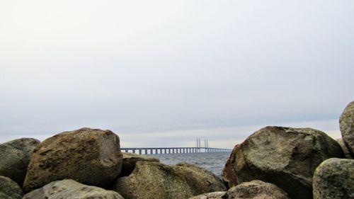 Rocks by sea against sky