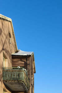 Low angle view of building against clear blue sky