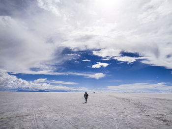 Man walking on land against sky