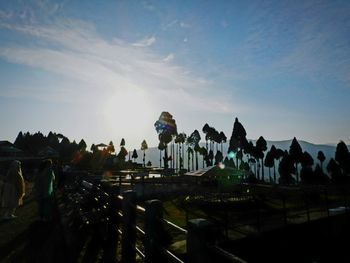 Crowd at amusement park against sky at night