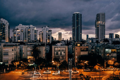 Illuminated cityscape against sky at night