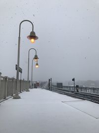 Street light on snow covered city